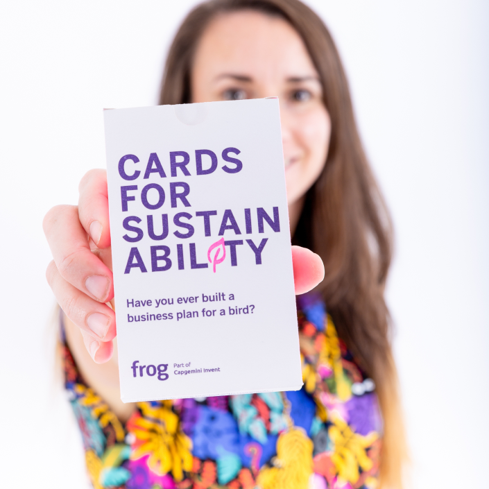 A person holding the boxed deck of Cards for Sustainability.